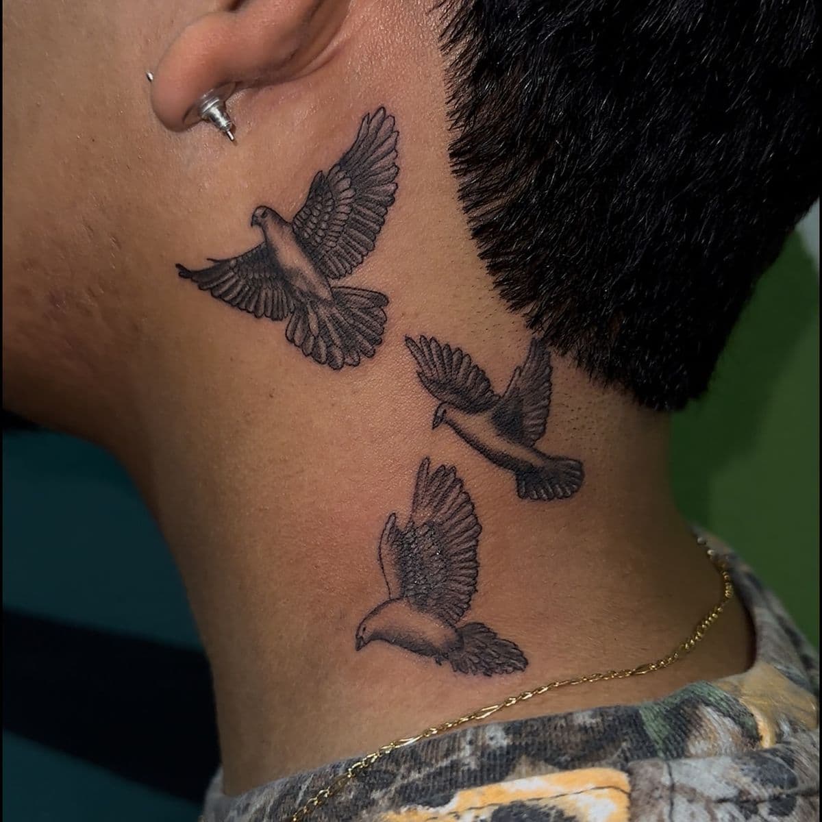 Three doves flying in formation on neck