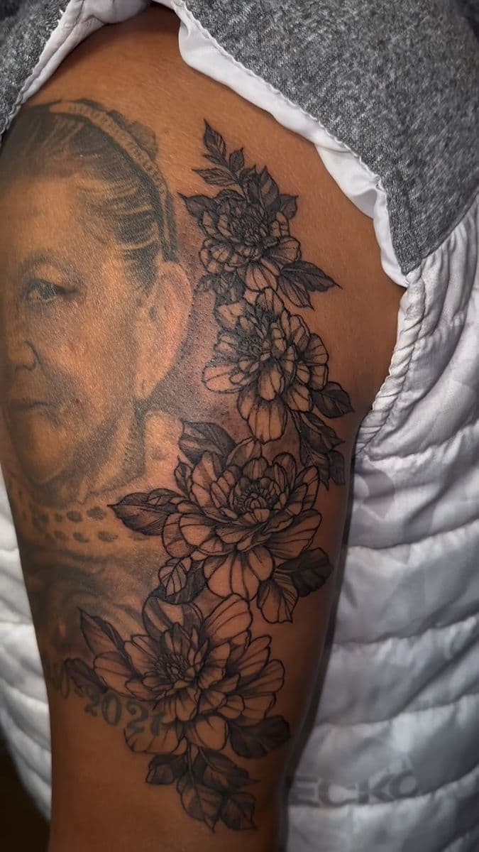 Black and grey portrait with peony flowers on thigh