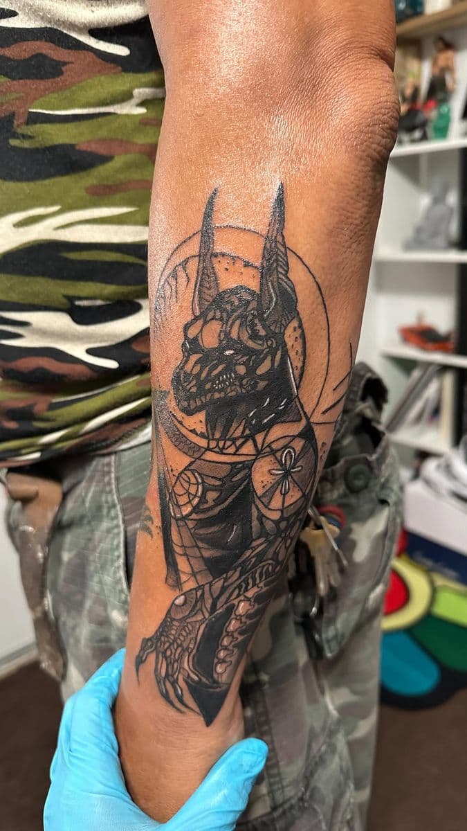 Anubis god holding ankh blackwork forearm piece